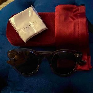 Gucci sunglasses-new. Gray with tortoise and red striped temples. Style GG0002S